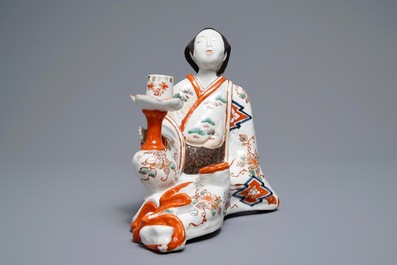 A Japanese Imari figure of a Bijin with candle holder, Edo, 17/18th C.