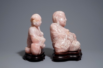 Two large Chinese pink quartz figures on wooden stands, 20th C.