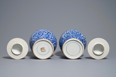 A pair of Chinese blue and white 'lotus scroll' vases and covers, 19th C.