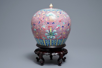 A Chinese famille rose jar and cover on wooden stand, 19th C.