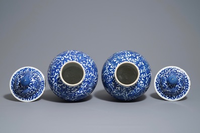 A pair of Chinese blue and white 'lotus scroll' vases and covers, 19th C.