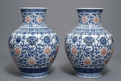 A pair of Chinese blue, white and iron red hu vases with taoist symbols, Qianlong mark, 20th C.