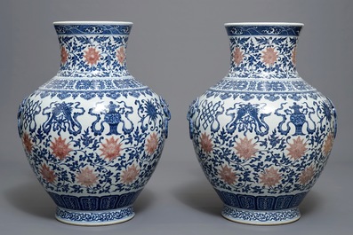 A pair of Chinese blue, white and iron red hu vases with taoist symbols, Qianlong mark, 20th C.