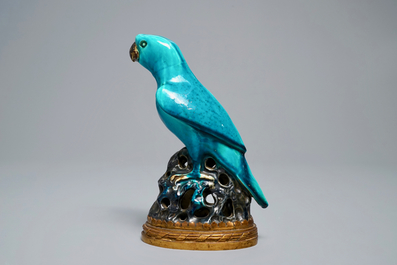 A Chinese turquoise-glazed parrot mounted on gilt bronze stand, Kangxi