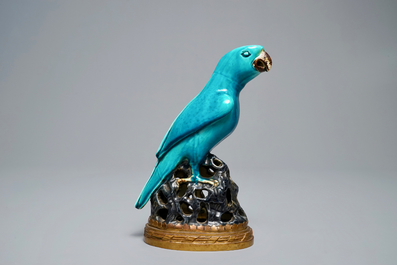 A Chinese turquoise-glazed parrot mounted on gilt bronze stand, Kangxi