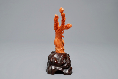 A Chinese carved red coral group of two ladies on wooden stand, 19/20th C.