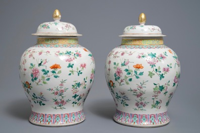 A pair of Chinese famille rose vases and covers with flowers and insects, 19th C.