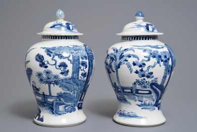 A pair of Chinese blue and white vases and covers, Kangxi mark, 19th C.