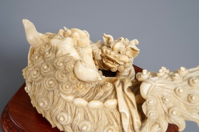 A Chinese ivory group of a Buddhist lion with cub, ca. 1920