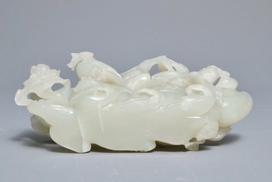 A Chinese celadon jade 'cranes' group on carved wooden base, Qing