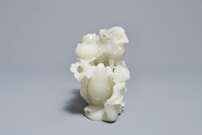 A Chinese celadon jade 'cranes' group on carved wooden base, Qing