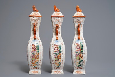 Three Chinese famille rose 'mandarin' vases and covers, Qianlong