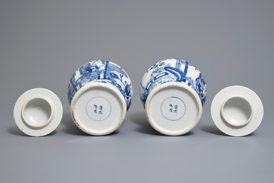 A pair of Chinese blue and white vases and covers, Kangxi mark, 19th C.