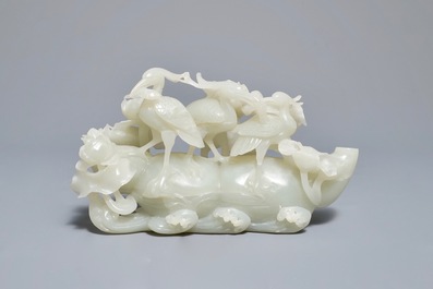 A Chinese celadon jade 'cranes' group on carved wooden base, Qing