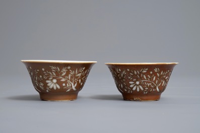 A pair of Chinese capucin ground cups and saucers with European wheel engraved design, Kangxi