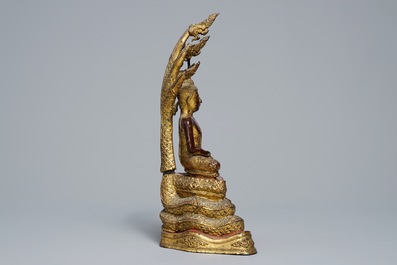An inlaid gilt-lacquered bronze figure of Buddha, Burma, 19th C.