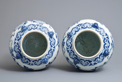 A pair of large Chinese blue and white vases and covers with birds among flowers, 19th C.