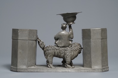 A large Chinese pewter double tea caddy with a central figure, impressed marks, 19th C.