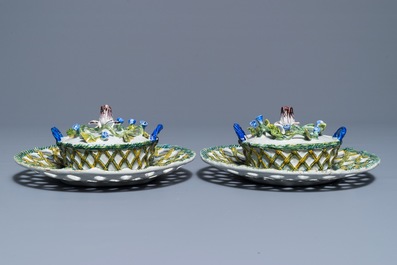 A pair of polychrome Dutch Delft butter tubs with applied design on reticulated stands, 18th C.