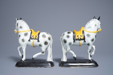 A pair of polychrome Dutch Delft black and yellow models of circus horses, 19th C.