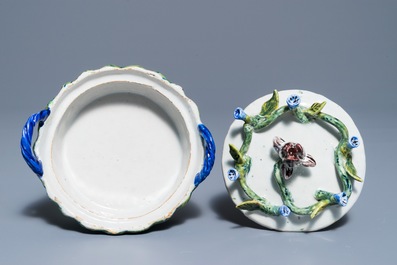 A pair of polychrome Dutch Delft butter tubs with applied design on reticulated stands, 18th C.