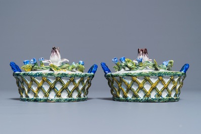 A pair of polychrome Dutch Delft butter tubs with applied design on reticulated stands, 18th C.