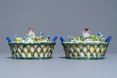 A pair of polychrome Dutch Delft butter tubs with applied design on reticulated stands, 18th C.