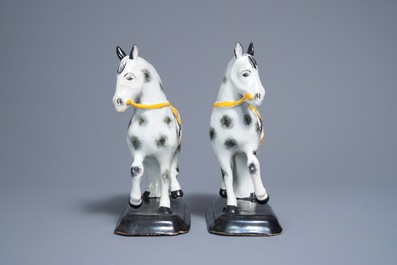 A pair of polychrome Dutch Delft black and yellow models of circus horses, 19th C.