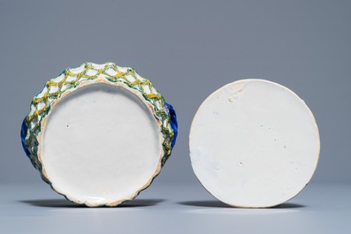 A pair of polychrome Dutch Delft butter tubs with applied design on reticulated stands, 18th C.