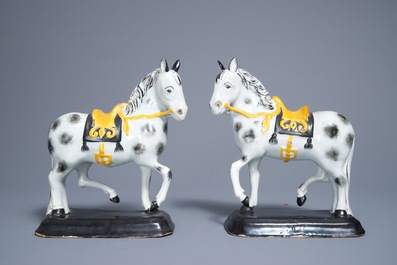 A pair of polychrome Dutch Delft black and yellow models of circus horses, 19th C.