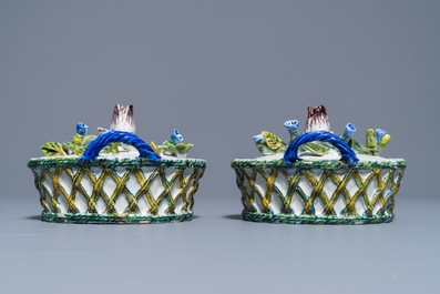 A pair of polychrome Dutch Delft butter tubs with applied design on reticulated stands, 18th C.