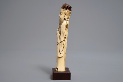 A Chinese Ming style carved ivory figure of a scholar, 19th C.