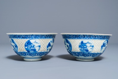 A pair of Chinese blue and white reticulated bowls with landscape panels, Transitional period