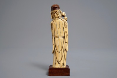 A Chinese Ming style carved ivory figure of a scholar, 19th C.