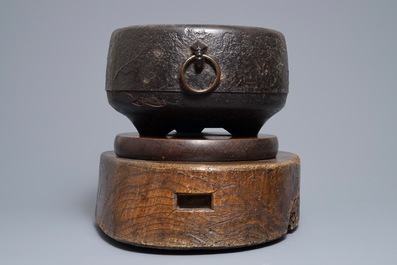 A Japanese relief-decorated cast iron furogama on wooden stand, Edo/Meiji, 18/19th C.