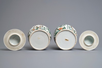 A pair of Chinese famille verte vases and covers with birds and flowers, 19th C.