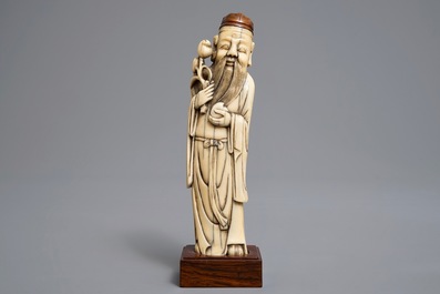 A Chinese Ming style carved ivory figure of a scholar, 19th C.