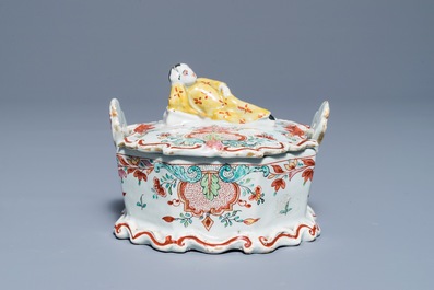 A polychrome Dutch Delft petit feu and dor&eacute; butter tub with a reclining Chinaman, 18th C.