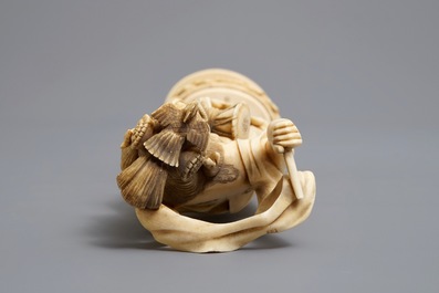 A Japanese carved ivory figure of a lady with a drum on a lotus throne, Meiji, 19th C.