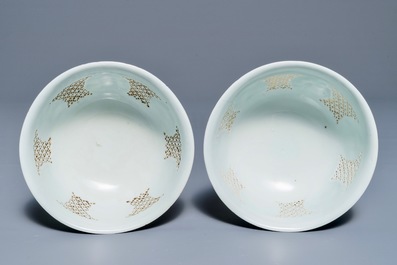 A pair of Chinese blue and white reticulated bowls with landscape panels, Transitional period