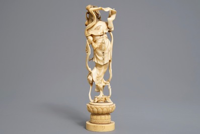 A Japanese carved ivory figure of a lady with a drum on a lotus throne, Meiji, 19th C.