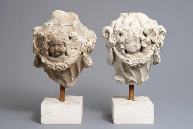 A pair of architectural stone ornaments with cherub's heads and garlands, 18th C.