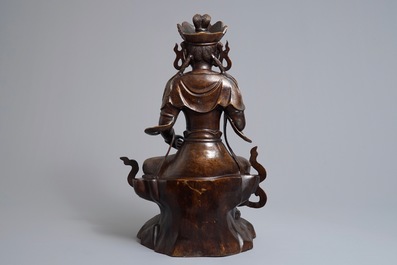 A large Chinese inlaid bronze model of Guanyin on a throne, 19/20th C.