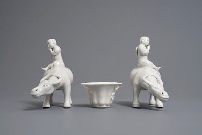 Two Chinese blanc de Chine groups of fluteplayers on buffalo and a floral wine cup, 18/19th C.