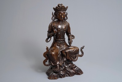 A large Chinese inlaid bronze model of Guanyin on a throne, 19/20th C.