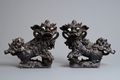 Two Chinese black-glazed roof tiles shaped as Buddhist lions, 19th C.