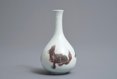 A Chinese copper-red bottle vase with mythical creatures, Kangxi