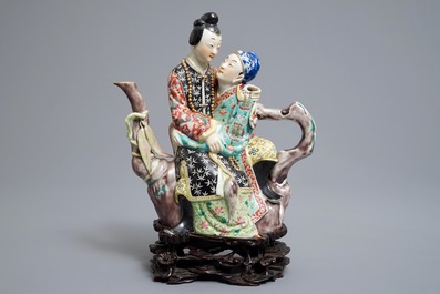 A Chinese famille rose semi-erotic teapot on wooden stand, Republic, 20th C.