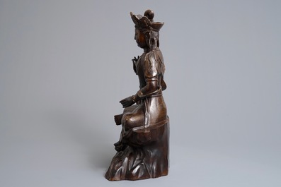 A large Chinese inlaid bronze model of Guanyin on a throne, 19/20th C.