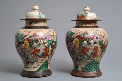 A pair of Chinese Nanking famille rose vases and covers with warriors, 19/20th C.